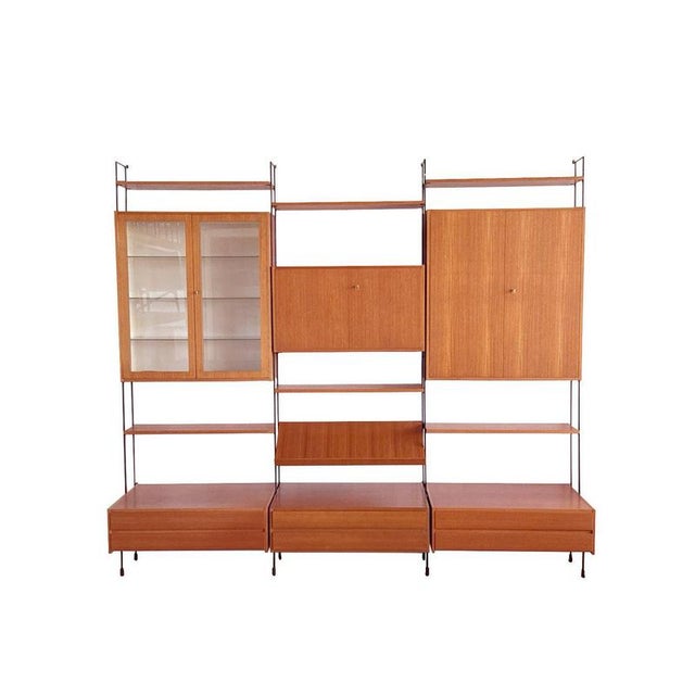 The Hilker Omnia walnut wall system from the 1960s embodies the understated elegance of German modernism, where...