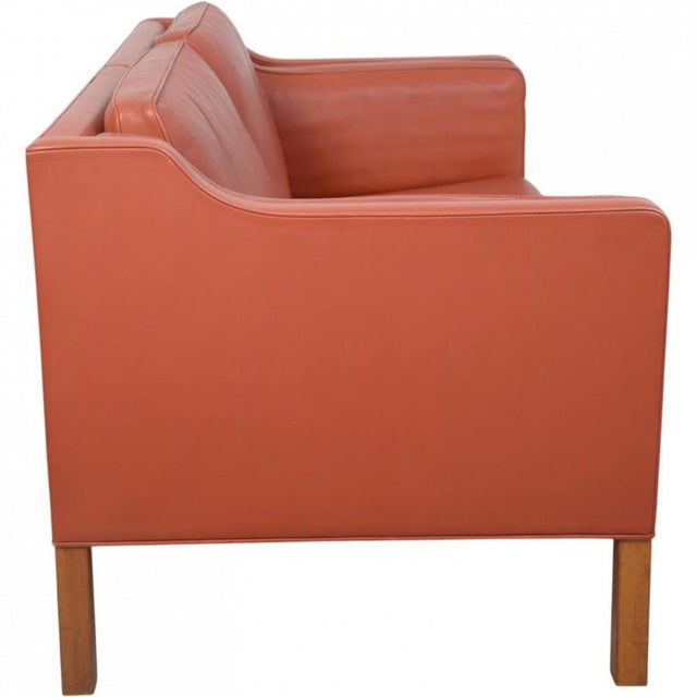 Børge Mogensen 2212 2.seater sofa upholstered in cognac red leather and with legs of mahogany. The sofa is from 1997 and...