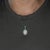 A large 8.41-carat Ethiopian opal cabochon flashes with a full play of color across this solid two-tone 14K white and...