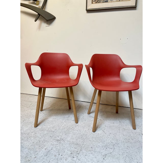 Pair of dark orange Vitra "Hal" armchairs with wooden legs. Perfect for the meeting room or the kitchen / dining table....