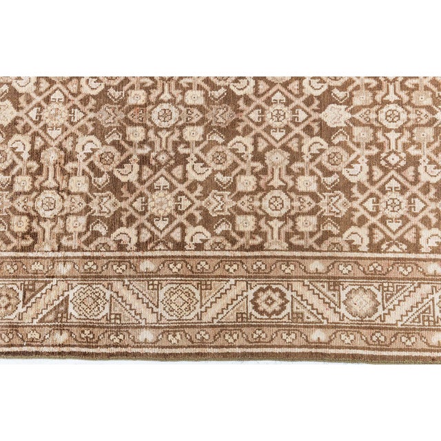 This antique Persian Malayer runner, circa early 20th century, relies heavily on exquisite oriental details as well as...