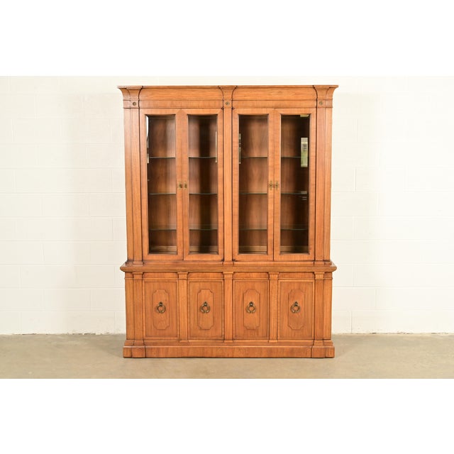 An exceptional Italian Neoclassical or Mediterranean style lighted breakfront bookcase cabinet or dining cabinet By...