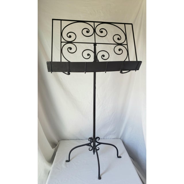 Vintage Adjustable Metal Music Stand, features intricate scrollwork on the music tray and an adjustable slanted top with...