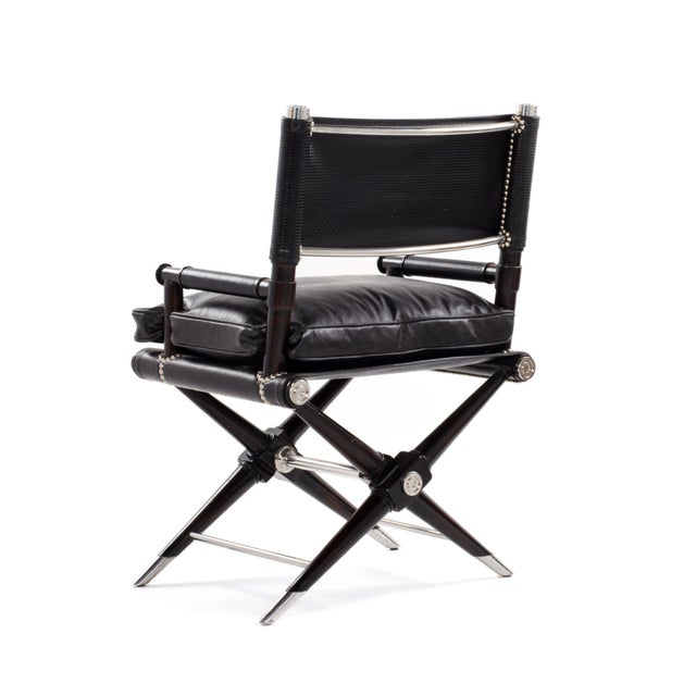 This sophisticated director’s chair by Theodore Alexander, crafted from solid mahogany with genuine black leather...