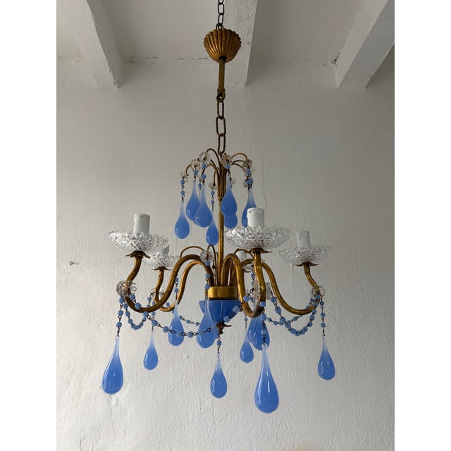 Housing 5 lights, sitting in crystal cups. Will be wired with certified sockets appropriate for country and ready to hang....