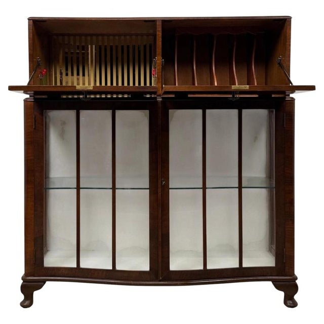 A charming and beautifully proportioned 20th-century figured walnut fitted cabinet, combining elegant traditional styling,...