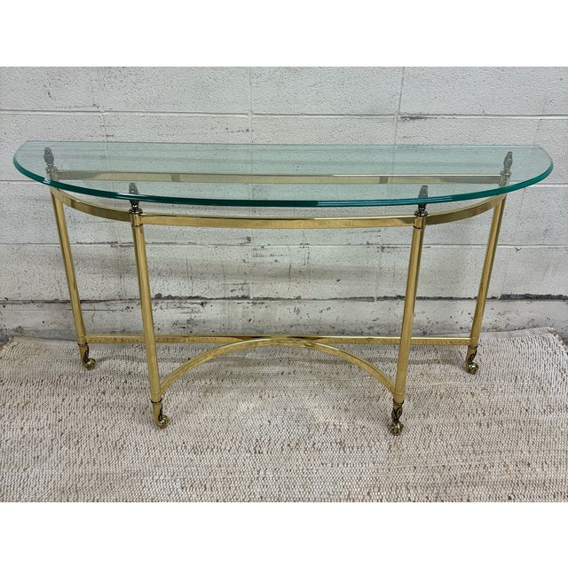 This is an absolutely beautiful vintage mid-century Hollywood Regency Labarge style brass and glass Demilune console...