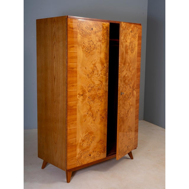A striking vintage mid-century wardrobe cabinet from Czechoslovakia, featuring a tall rectangular form, two large front...