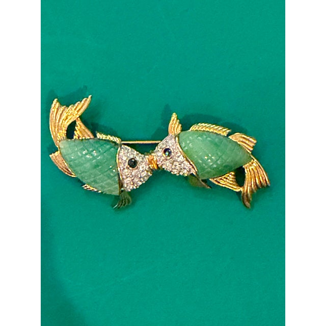 1980's kissing fish brooch by jewelry designer Kenneth Jay Lane. These cheeky gold-tone fish have green lucite bodies...