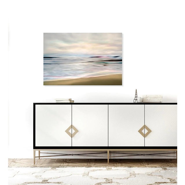 Beautiful Mavillette Beach seascape in Nova Scotia is captured at the end of the day. Notice the nuances of pink and...