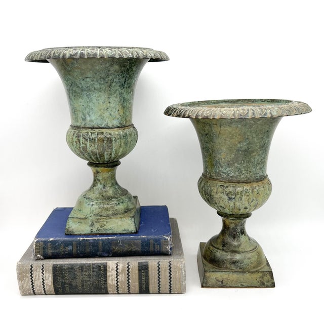 Superb pair of cast iron urns with gorgeous verdigris patina. Would look incredible displaying boxwood greenery balls or...
