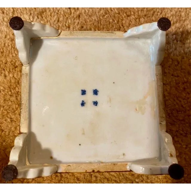 a Chinese porcelain box signed with four blue character marks. This has been broken and repaired in several places. If you...