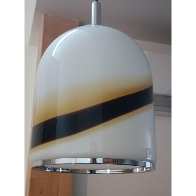 Beautiful pendant lamp. Italy, 1970s. Chrome-plated metal frame. It supports a magnificent thick Murano opaline glass...