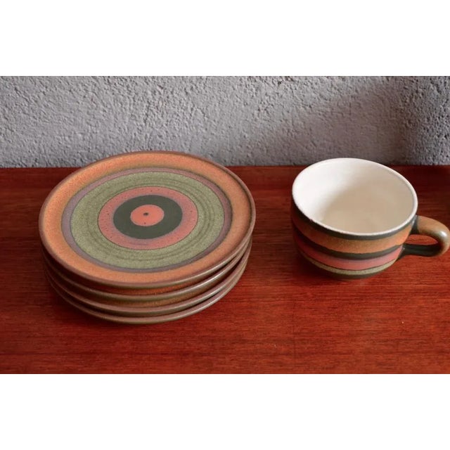 This ceramic tea or coffee set dates back to the 1960s. With its colourful stripes on the outside of the cups and white...