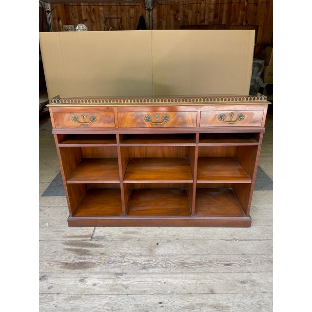 A slanted top library writing desk from Baker Furniture Stately Homes Woburn Abbey Collection. This desk features a...