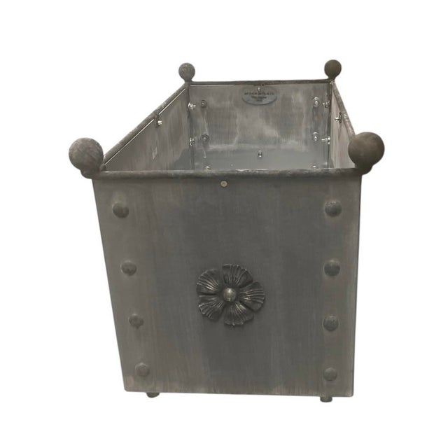 A rectangular trough planter crafted from steel with a hand-applied charcoal patina that gives it the look of aged zinc or...