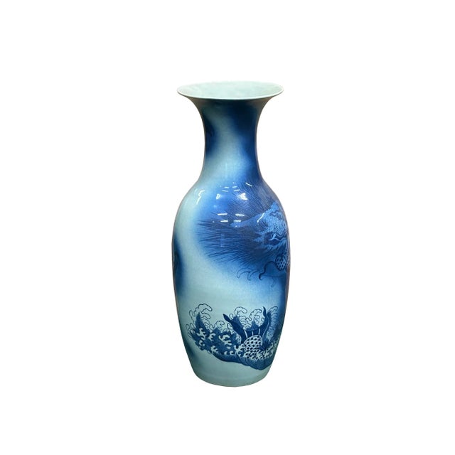 This striking pair of blue and white vases is a breathtaking example of traditional artistry, featuring a majestic dragon...