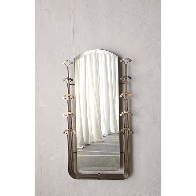 This is a unique and rare wall mirror by Curtis Jere. The mirror has a very art deco vibe. The arch shape and fluted metal...