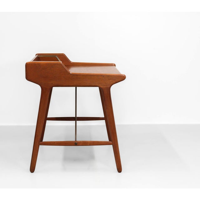 Scarce small teak desk with brass structural elements designed by architect Svend Age Madsen and produced by K. Knudsen &...