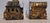 A vintage 1960s pair of copper-tone metal bookends with a Western theme: one depicts a Wells Fargo stagecoach with luggage...