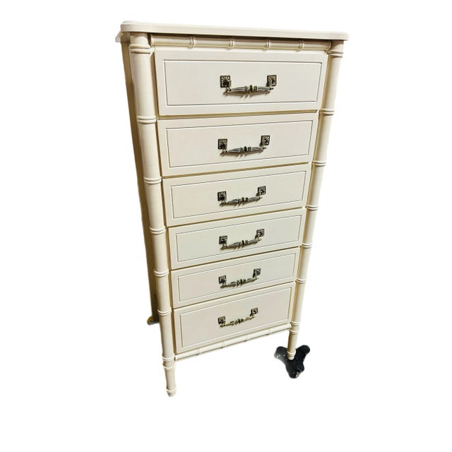 A faux bamboo six drawer lingerie chest with original hardware. The light yellow chest is built solidly with dovetail...