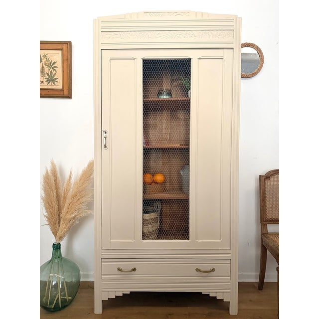 This stunning French armoire is a masterclass in blending the geometric elegance of the Art Deco period with the rustic...