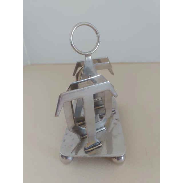 Plated silver toast holder from England. The word toast spelled out give this a modern look of a traditional item.
