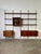 Iron and wood wall bookcase by Osvaldo Borsani E22 production Tecno 1960s Modular wall-mounted bookcase made of wood and...