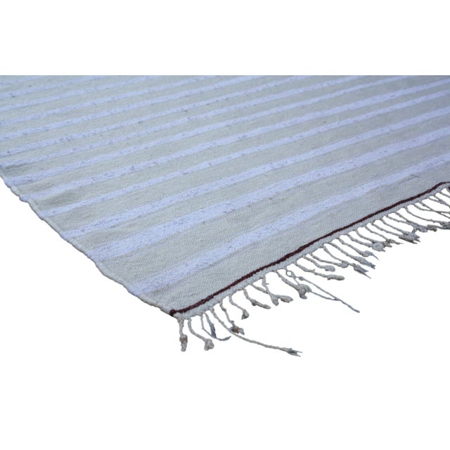 One-of-a-kind Moroccan Berber blanket handloomed of soft organic wool with Berber stripes on a beige background. Great as...