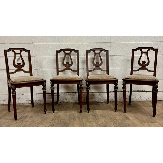 This is a gorgeous set of four vintage, possibly antique, French Louis XVI style harp back or lyre back dining chairs with...