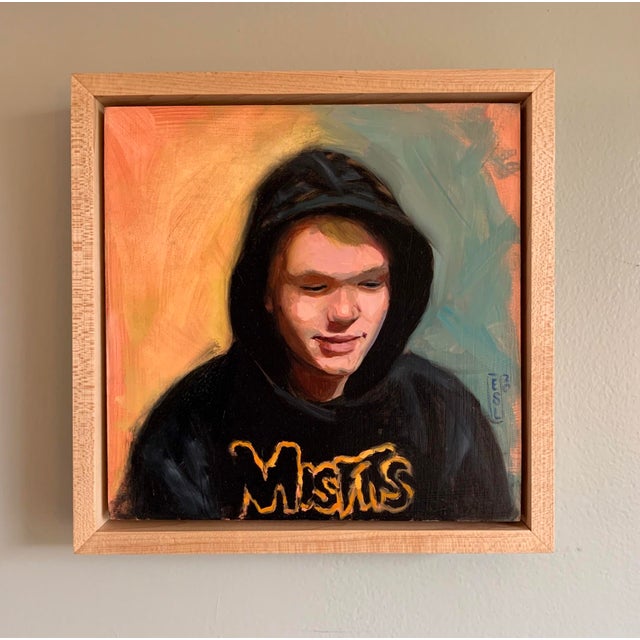 This oil on panel artwork features a young figure clad in a black hoodie emblazoned with the word "Misfits," exuding a...