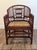 A striking vintage Brighton Pavilion–style accent chair with an intricate bamboo-inspired frame, decorative fretwork, and...