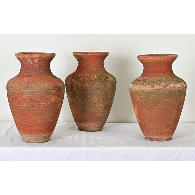 Dimensions: 19 ½” H x 13” W x 13” D A beautiful set of three, unglazed terracotta olive jars from Turkey, circa 1930, by...