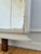 An antique European full-length floor mirror, dating to the early 20th century. The mirror glass has a beveled edge and is...