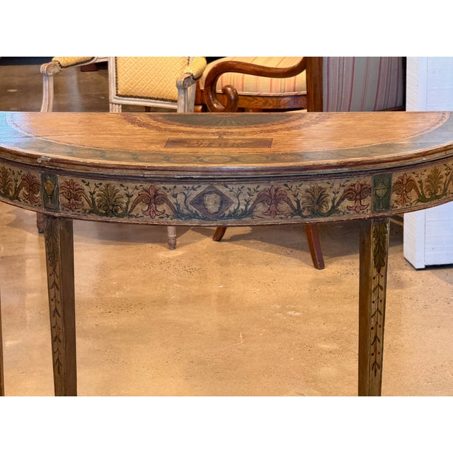 A exceptional 19th century Italian painted demi-lune console with decoration covering every surface. The top is painted...