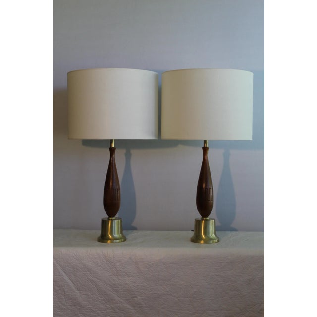 Beautiful pair of Mid Century modern table lamps. Turned walnut that has interesting etched design. mounted on brushed...