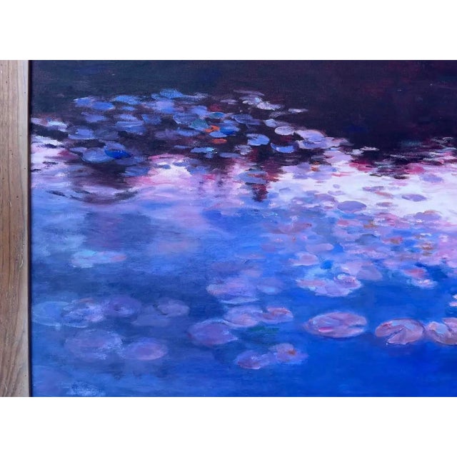 Atmospheric vintage oil painting depicting a water lily pond transformed by the colors and reflections of the evening sky....