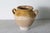 This 19th-century Spanish terracotta glazed pottery jar, exemplifies rustic elegance and traditional craftsmanship....