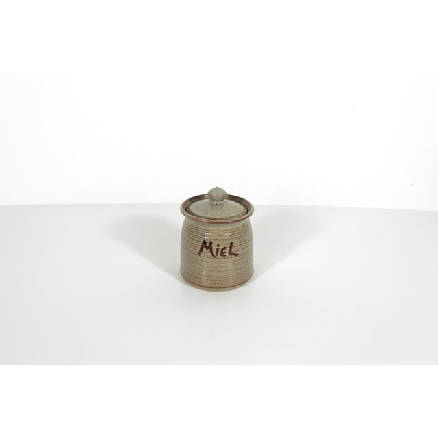 Handmade, vintage stoneware honey pot. It is in great condition with no chips or cracks detected. It says MIEL which is...
