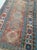 Antique hand-knotted 100% pure wool pile on wool foundation gallery rug featuring a terracotta field with geometric...