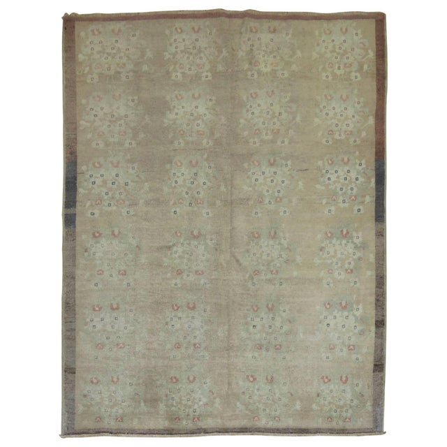 Mid-Century one of a kind Turkish rug with casual floral motif in camels, soft green and apricot surrounded by a soft...