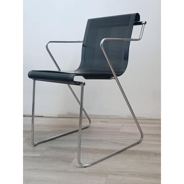 Beautiful Monopoli armchair by Pietro Arosio for Airon. Italy, 1970s. Black lacquered perforated metal frame. Chrome-...