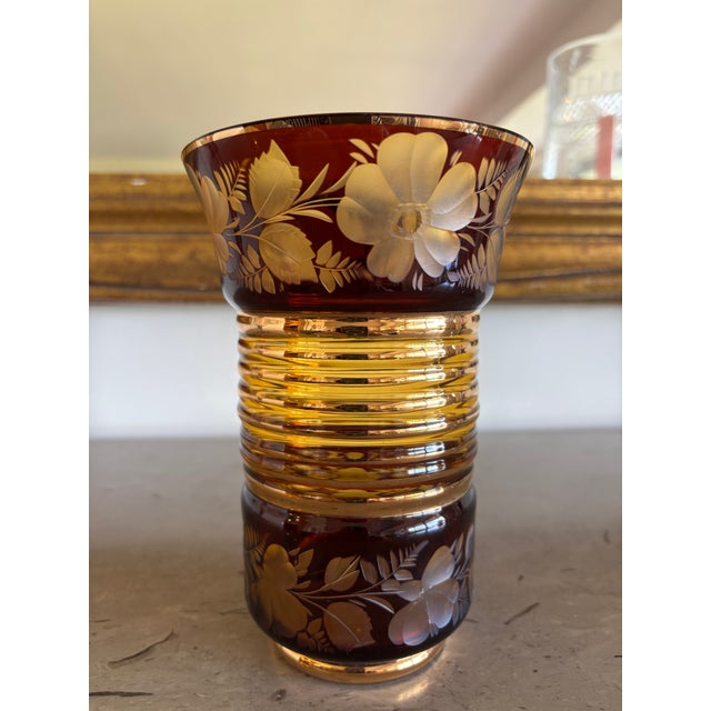 This striking 8 inch vase is a classic example of Bohemian craftsmanship. It features an intricately etched floral motif...