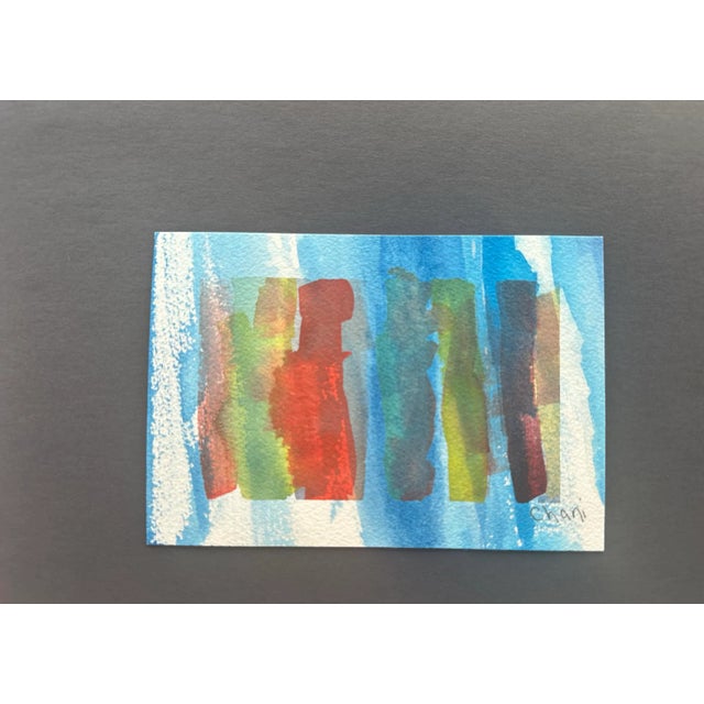 A striking composition dominated by cool blue tones with earthy greens, rich reds, and deep browns. The vertical forms...