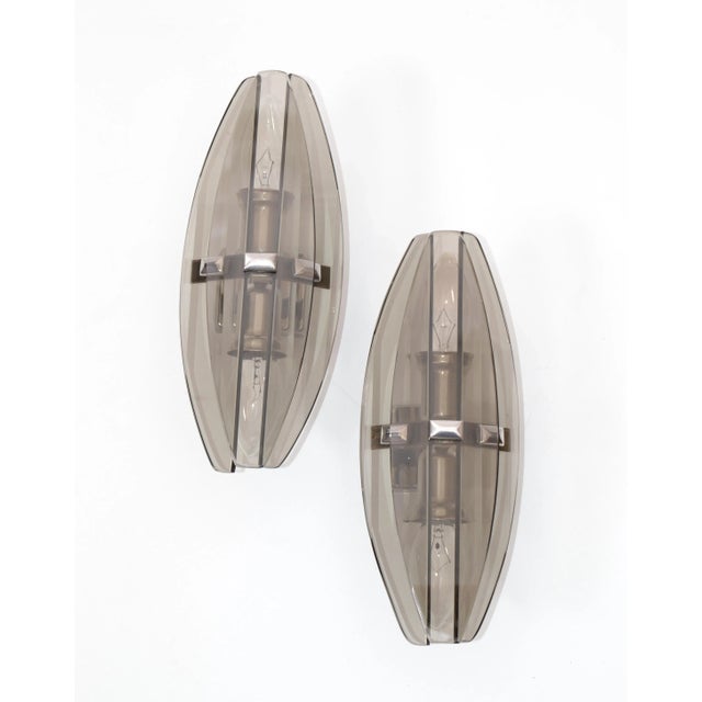 Italian Mid-Century Modern superb pair of smoked glass blades wall sconces styled after Fontana Arte. Each sconce takes 2...