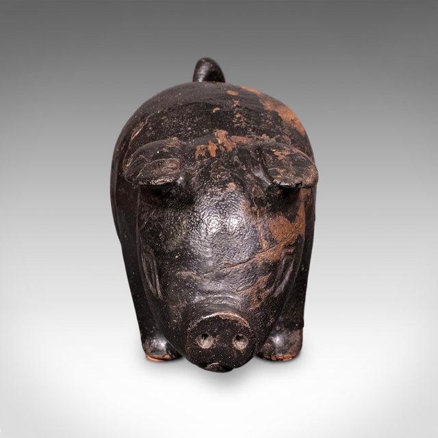 This is a vintage carved piglet figure. An English, ebonised treen in farmyard animal form, dating to the mid 20th...