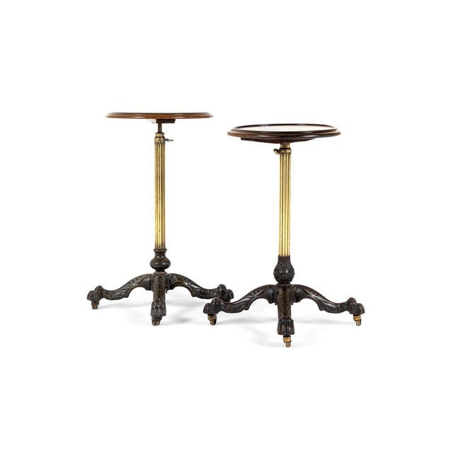 A fabulous near pair of 19th century occasional tables with mahogany tops accompanied with a cast iron base. the circular...