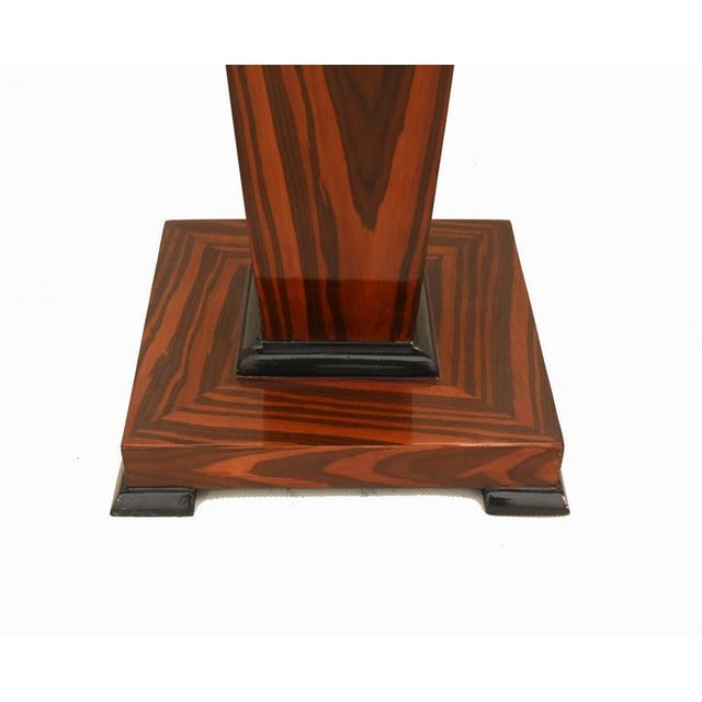 A superb pair of Art Deco style pedestal stands veneered in richly figured macassar ebony Each pedestal features a...