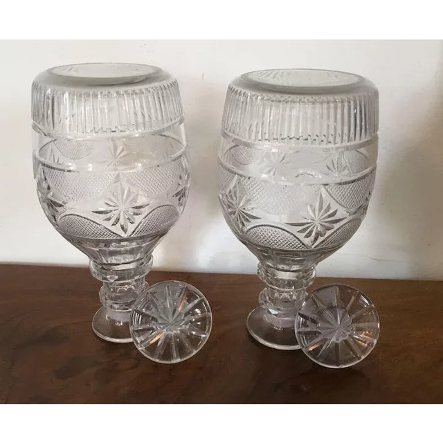 A good pair of antique 19th c. Anglo Irish Georgian glass spirit decanters and stoppers profusely cut with a central band...