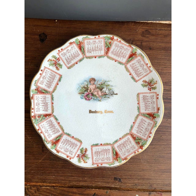 Add a touch of turn-of-the-century charm to your holiday or antique collection with this lovely 1910 calendar porcelain...